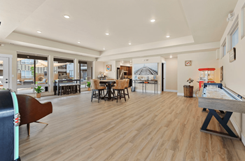 A room with a pool table and a piano.